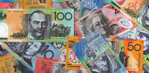 Australian dollar banknotes of various denominations are arranged for a photograph in Sydney. BlackRocku2019s Miller predicts the currency will fall to 65 cents and probably lower by the end of this year, more bearish than the median forecast for it to end 2016 at 70 cents.