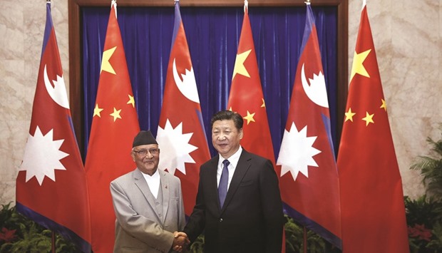 Chinese President Xi Jinping, right, shakes hands with Nepalese Prime Minister K P Sharma Oli during a meeting at the Great Hall of the People in Beijing yesterday.