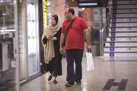 Customers browse the window displays of retail outlet inside an electronics store in Tehran. While international sanctions imposed over Iranu2019s nuclear activities were lifted in January following the deal with world powers last year, others related to alleged links to terrorism and ballistic missiles remain in force. That could impede Iranu2019s efforts to attract as much as $50bn a year in foreign investment.