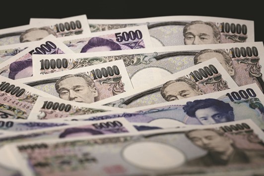 Yen banknotes of various denominations are arranged for a photograph in Tokyo. Bank of Tokyo-Mitsubishi UFJ, Sumitomo Mitsui Banking Corp and Mizuho Bank all see the yen ending the year stronger than where it started.