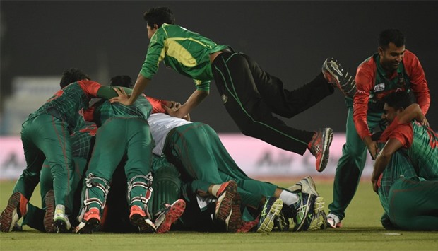 Bangladesh cricketers celebrate after winning against Pakistan