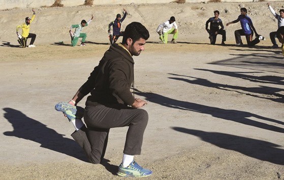 Local cricketers warm up at an academy in Quetta, Pakistan. (AFP)