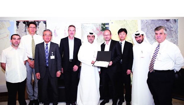 Ashghal's al-Khayarein honouring the project contractor Suez u2013 Marubeni joint venture as other officials look on