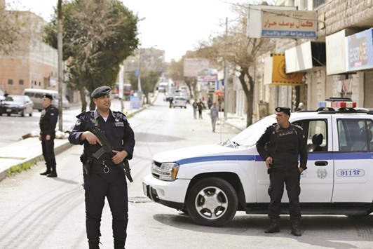 Officers of the Jordanian public security department stand guard in the northern city of Irbid.