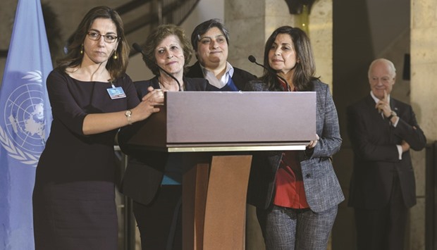 Members of the Syrian Women Advisory Board attend a press briefing next to UN Syria envoy Staffan de Mistura yesterday following a meeting during Syria peace talks at the UN in Geneva.