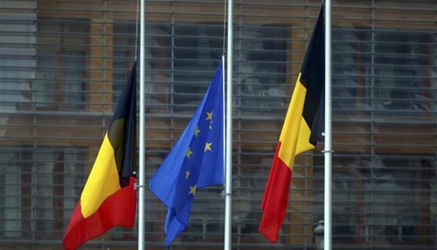 Belgian and European Union flags fly at half mast on Wednesday following the bomb attacks in Brussels.