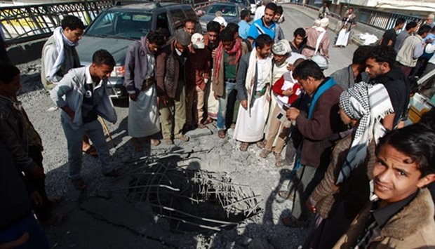 Yemenis check damage following reported air strikes by the Saudi-led coalition in Sanaa on Wednesday.