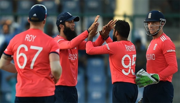 England's Adil Rashid (2R) celebrates with teammates