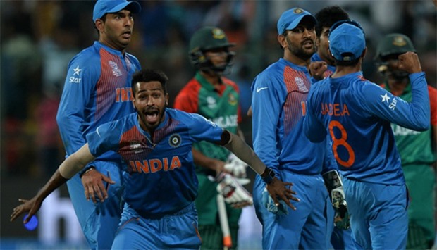 Indian bowler Hardik Pandya(2L)celebrates the wicket that led to the victory of India in the last ba