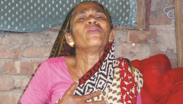 The relative of a man killed during post-election violence reacts in Pirojpur.