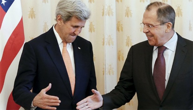 Russian Foreign Minister Sergei Lavrov (R) shakes hands with US Secretary of State John Kerry