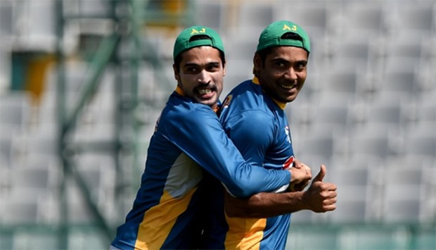 Pakistan's Rashid Latif (R) and Mohammad Amir (L) shares a light moment as they train