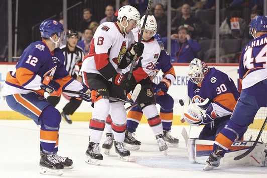New York Islanders goalie Jean-Francois Berube (second from right) makes a save in front of Ottawa Senators left wing Nick Paul (second from left) and Ottawa Senators left wing Matt Puempel (centre) during their NHL game on Wednesday. (USA TODAY Sports)