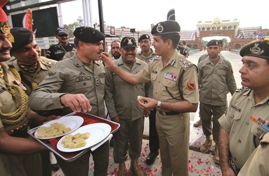 Officers of Indiau2019s Border Security Force and Pakistan Rangers exchange sweets, on the occasion of the Indian festival of Holi, on Attari-Wagha border yesterday.