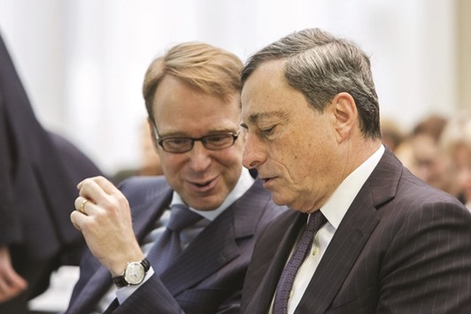 Bundesbank President Jens Weidmann speaks to ECB President Mario Draghi during the SUERF money and finance forum in Frankfurt on February 4. ECB policy makers were right to step up euro-area stimulus this month, though the full package of rate cuts, bond purchases and free loans went too far, Weidmann said on Wednesday.