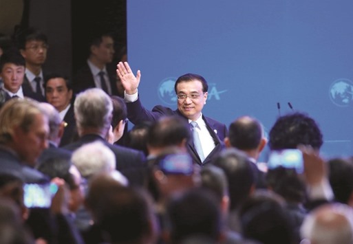 Chinau2019s Premier Li Keqiang waves as he arrives at the opening ceremony of Boao Forum in Hainan Province. Addressing the forum, Li said high economic growth rates are not sustainable, so the government will pay more attention to the quality and efficiency of economic growth.