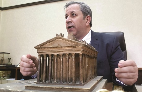 Syriau2019s antiquities chief Maamoun Abdelkarim discusses a model of the Bel Temple during an interview with AFP at his office in Damascus.