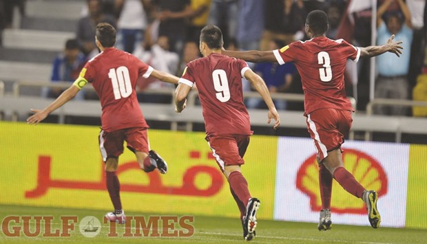 Qatar captain Hassan al-Haidos (left) celebrates with teammates after scoring yesterday. PICTURES: Noushad Thekkayil