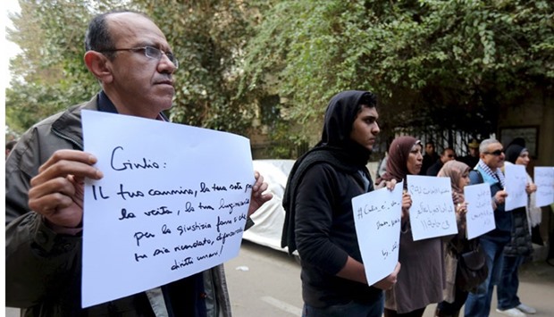 Activists hold placards, which read, among others, ,Giulio, one of us and killed like us,, during a memorial for Italian Giulio Regeni outside the Italian embassy in Cairo, Egypt, February 6, 2016. Reuters