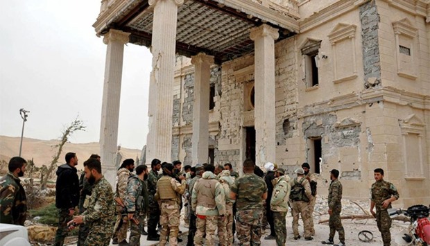 Forces loyal to Syria's President Bashar al-Assad gather at a palace complex on the western edge of Palmyra