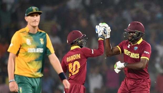 West Indies batsmen Carlos Brathwaite (right) and Denesh Ramdin celebrate after winning the World T20 match against South Africa in Nagpur on Friday.