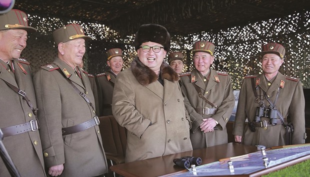North Korean leader Kim Jong-Un with military officers as he oversees a military drill at an unknown location, in this undated photo released by North Koreau2019s Korean Central News Agency.