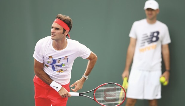 Roger Federer of Switzerland is watched by new coach Ivan Ljubicic.
