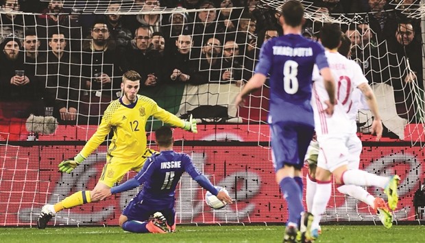 Italy forward Lorenzo Insigne scores past Spain goalkeeper during their friendly in Udine on Thursday. (AFP)