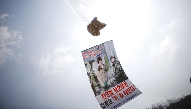 A balloon containing leaflets denouncing North Korean leader Kim Jong-Un is seen yesterday near the demilitarised zone separating the two Koreas in Paju, South Korea, on the sixth anniversary of the sunken naval ship Cheonan. The lettering on the banner reads u2018Merciless attacks on nuclear addict Kim Jong-Unu2019 (top) and u2018Sprits of deceased 46 navy sailors on the sunken naval ship Cheonan want Kim Jong-Unu2019s lifeu2019.
