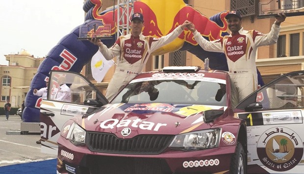 Qataru2019s Nasser Saleh al-Attiyah (R) and co-driver Matthieu Baumel celebrate their Kuwait Rally win yesterday.
