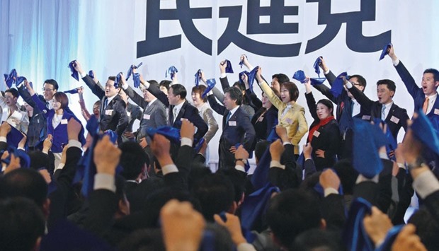 Parliament members of the main opposition Democratic Party wave blue handkerchiefs during the partyu2019s inauguration ceremony in Tokyo yesterday.