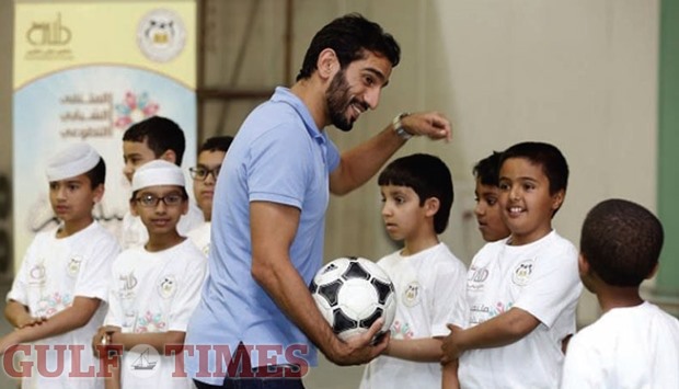 Adel Lamy interacting with schoolchildren at the  Khalifa Stadium.