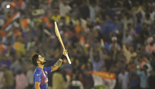 Indiau2019s Virat Kohli celebrates after victory in the World T20 cricket tournament match between India and Australia at The Punjab Cricket Association Stadium in Mohali.