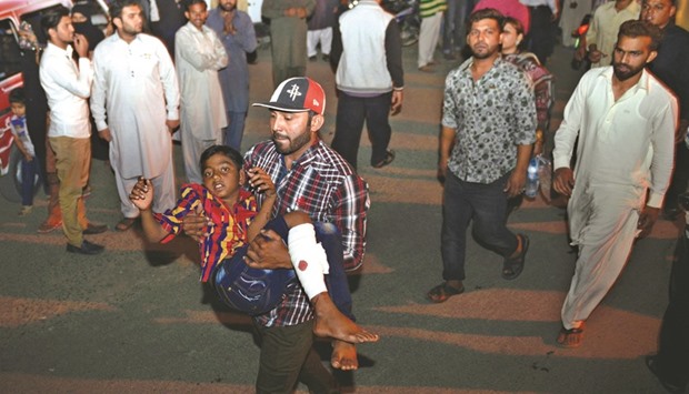down and many of the cityu2019s main roads were deserted. A man carrying an injured child to the hospital after the blast in Lahore.