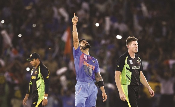 Virat Kohli (centre) celebrates Indiau2019s win as Australiau2019s James Faulkner (right) and Usman Khawaja walk off dejected, in Mohali on Sunday night. (Reuters)