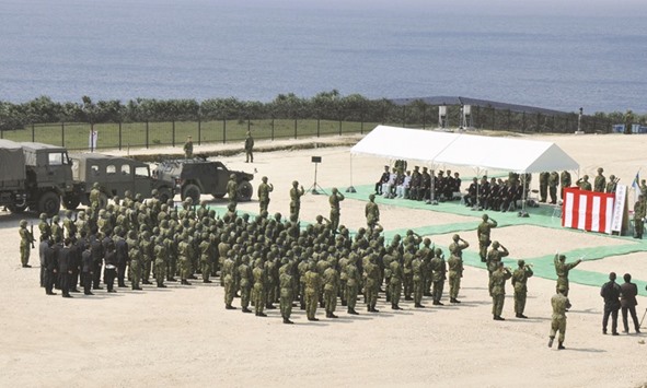 Members of Japanu2019s Self Defence Force holding an opening ceremony of a new military base on the island of Yonaguni in the Okinawa prefecture yesterday.
