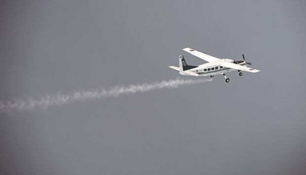 A  Cessna 208 Caravan aircraft from the Thai Department of Royal Rainmaking depositing a sodium chloride-based material above clouds in Nakhon Sawan in an effort to produce rain.