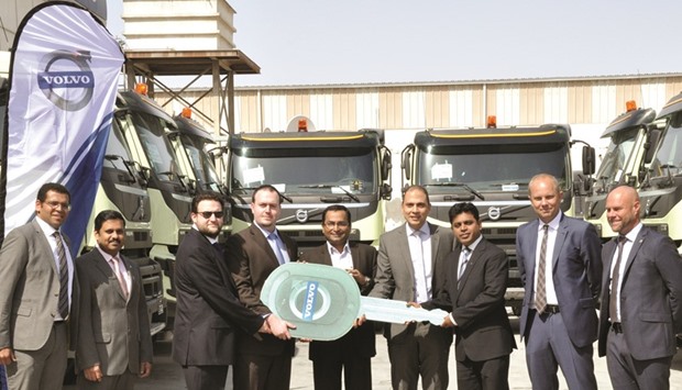 Domasco and Desert Stream officials at the handover of the 42 Volvo FMX trucks to the latter.