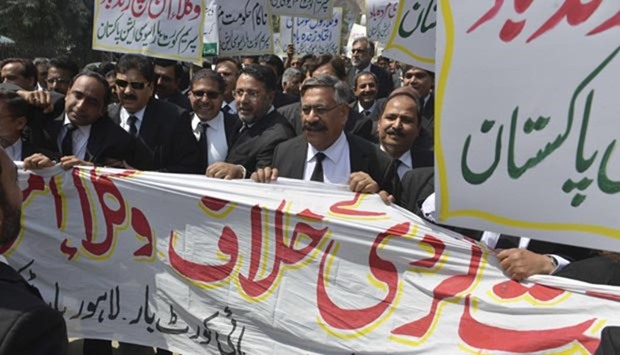 Pakistani lawyers march during a protest against a suicide bomb attack which killed more than 70 people in Lahore.