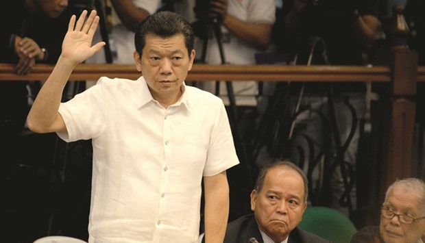 Casino junket operator Kim Wong takes an oath during a senate hearing in Manila yesterday.
