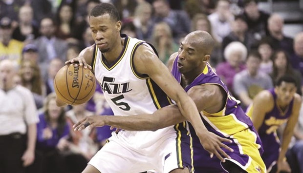 Los Angeles Lakers forward Kobe Bryant (R) defends against Utah Jazz guard Rodney Hood.