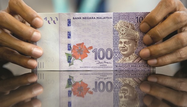 Malaysian ringgit banknotes are counted at the RHB Investment Bank headquarters in Kuala Lumpur. A recovery in crude prices has helped make the ringgit Asiau2019s best-performing currency this year.