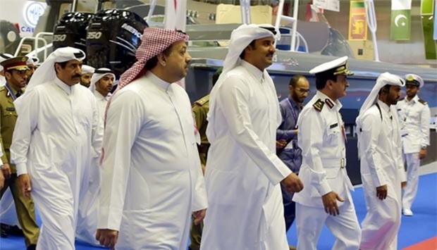 HH the Emir Sheikh Tamim bin Hamad al-Thani, adviser to the Emir for Defence Affairs HE Major General Hamad bin Ali al-Attiyah and HE the Minister of State for Defence Affairs HE Dr Khalid bin Mohamed al-Attiyah touring the Dimdex 2016 at the Qatar National Convention Centre on Tuesday.