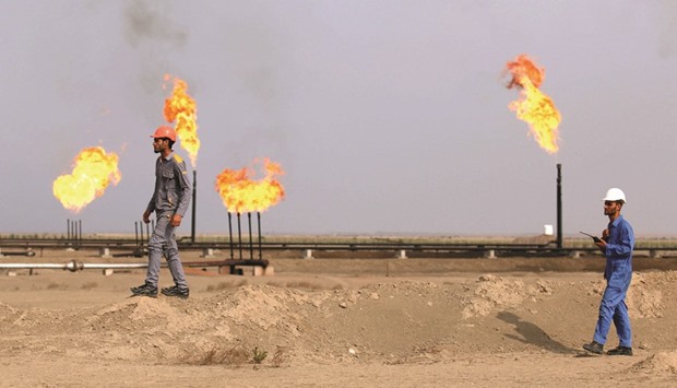 Iraqi labourers work at an oil refinery in the southern town Nasiriyah. The country currently wastes associated gas that occurs naturally with oil underground by flaring it off and ranks as the worldu2019s fourth-largest gas-flaring nation, according to Shellu2019s website.