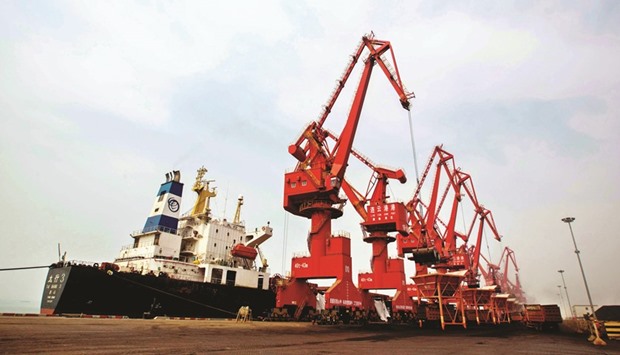 Imported coal being unloaded from a cargo ship at a port in Lianyungang, Jiangsu province. Chinau2019s GDP growth is expected to slow to 6.5% in 2016, the ADB said in its flagship Asian Development Outlook yesterday, lowering its December forecast of 6.7%.