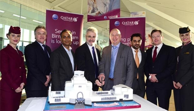 Officials and dignitaries are pictured with a celebratory cake replicating Doha's Museum of Islamic Art to mark the occasion