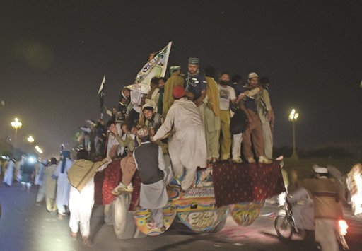 Pakistani supporters of convicted murderer Mumtaz Qadri celebrate as they leave after their leaders announced the end of a protest held in front of the parliament building in Islamabad yesterday.