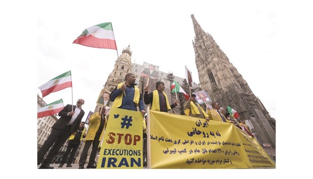 People protest against Iranian President Hassan Rouhani during a demonstration denouncing Iranu2019s use of the death penalty yesterday in Vienna, Austria. Rouhaniu2019s state visit to Austria scheduled for March 30-31 has been postponed.