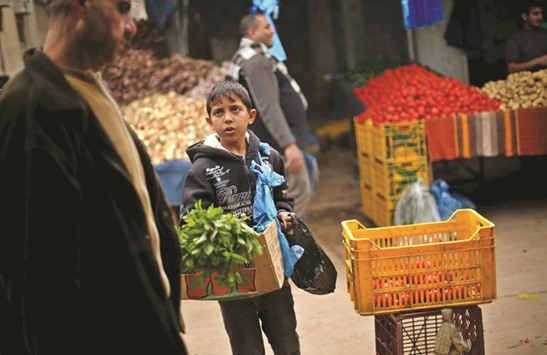 Palestinian boy Mohamed al-Bana, 10, sells mints at a market in Gaza City. Bana, whose father is unemployed, earns around 10 Shekels ($2.5) per day. The boy starts working after finishing school. He hopes to continue education and become an engineer in the future.