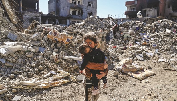 Children stand among the rubble of damaged buildings in Cizre, southeastern Turkey. Thousands in Turkeyu2019s Kurdish-majority town of Cizre started returning to their homes yesterday after authorities partially lifted a curfew in place since December.